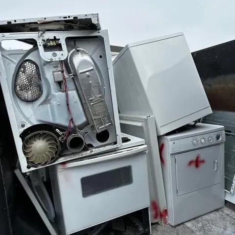 a bunch of old appliances are stacked on top of each other .