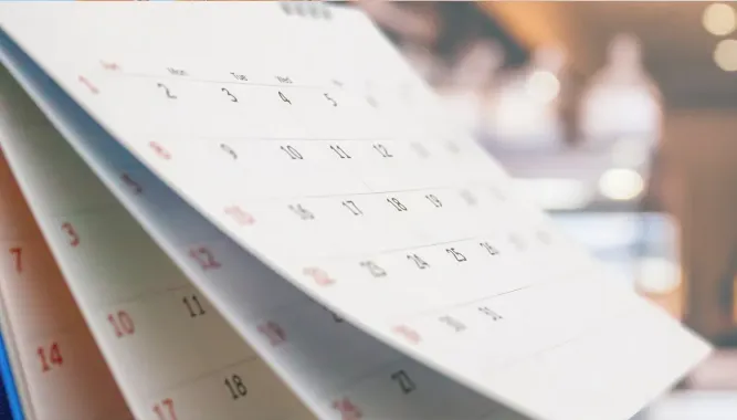 A close up of a calendar on a table.