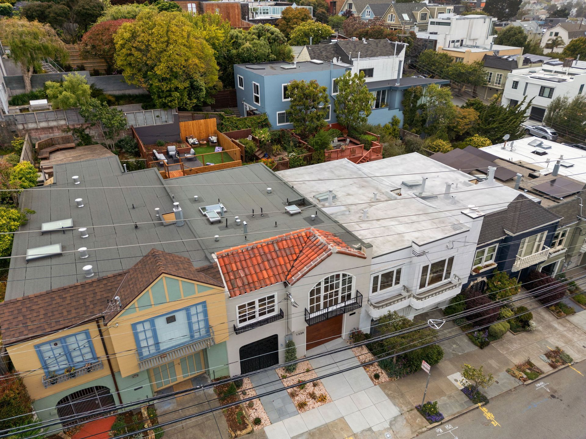 Aerial view of colorful row houses and rooftops in a residential neighborhood