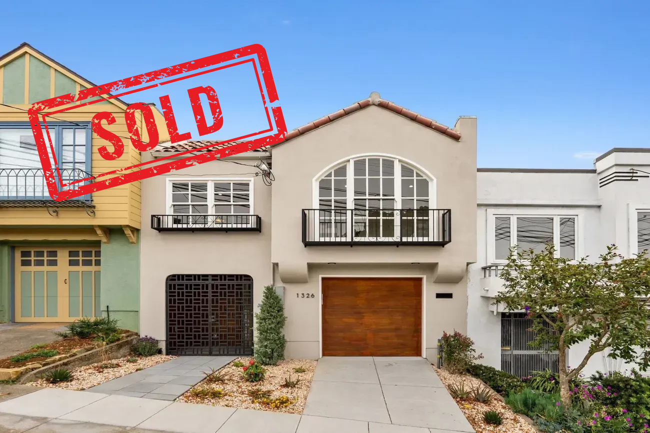 Two-story house with a red SOLD stamp over the top left corner
