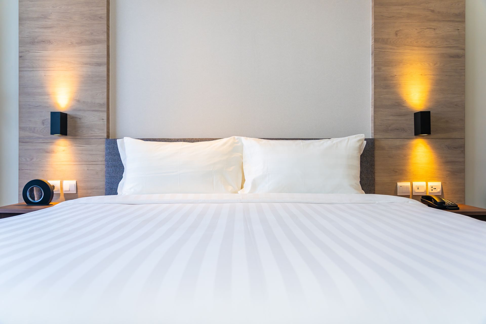 White pillows arranged on a neatly made bed in a comfortable bedroom.