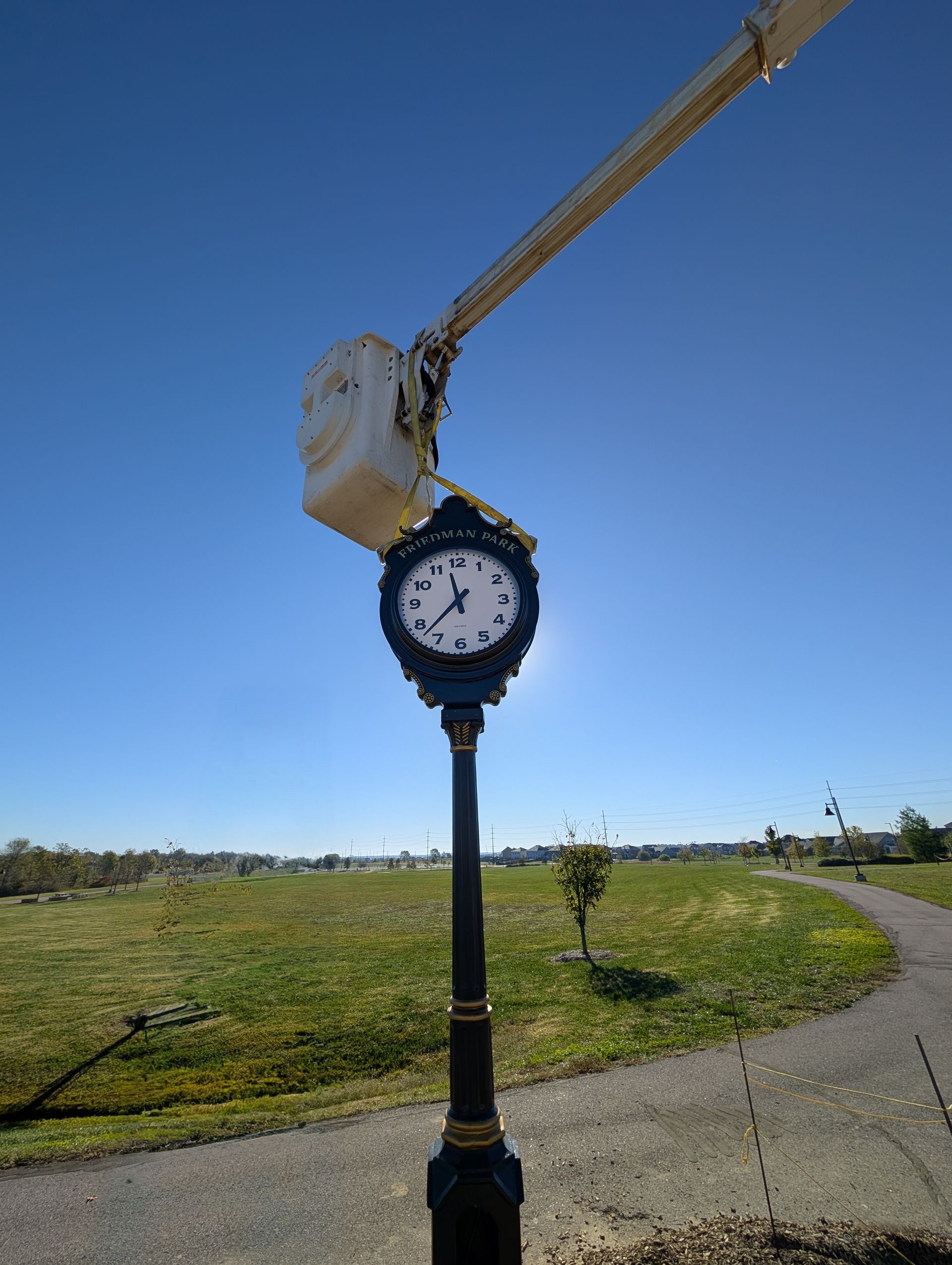 a bucket truck installing a clock