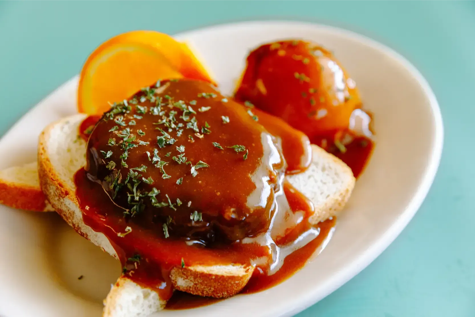 Baked eggs with tomato sauce and herbs on toast in a white bowl