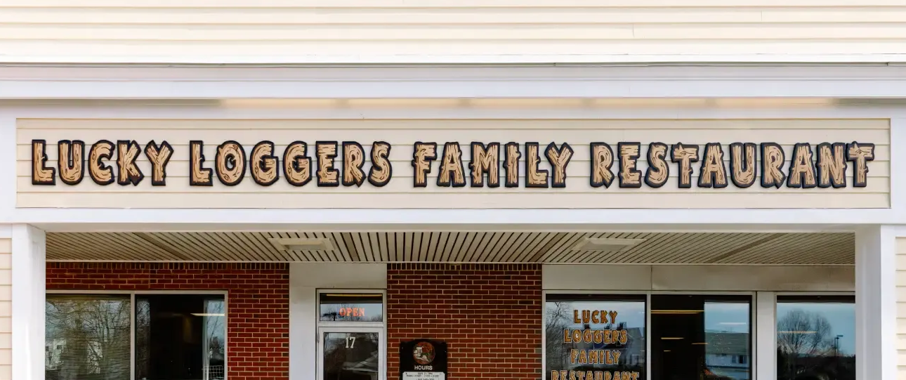 Storefront sign reading “Lucky Loggers Family Restaurant” above the entrance