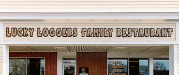 Storefront sign reading “Lucky Loggers Family Restaurant” above the entrance