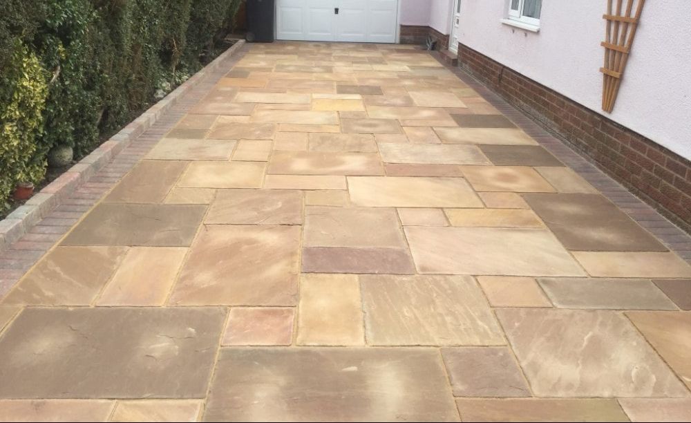 Buff Indian stone driveway beside a house in Rotherham