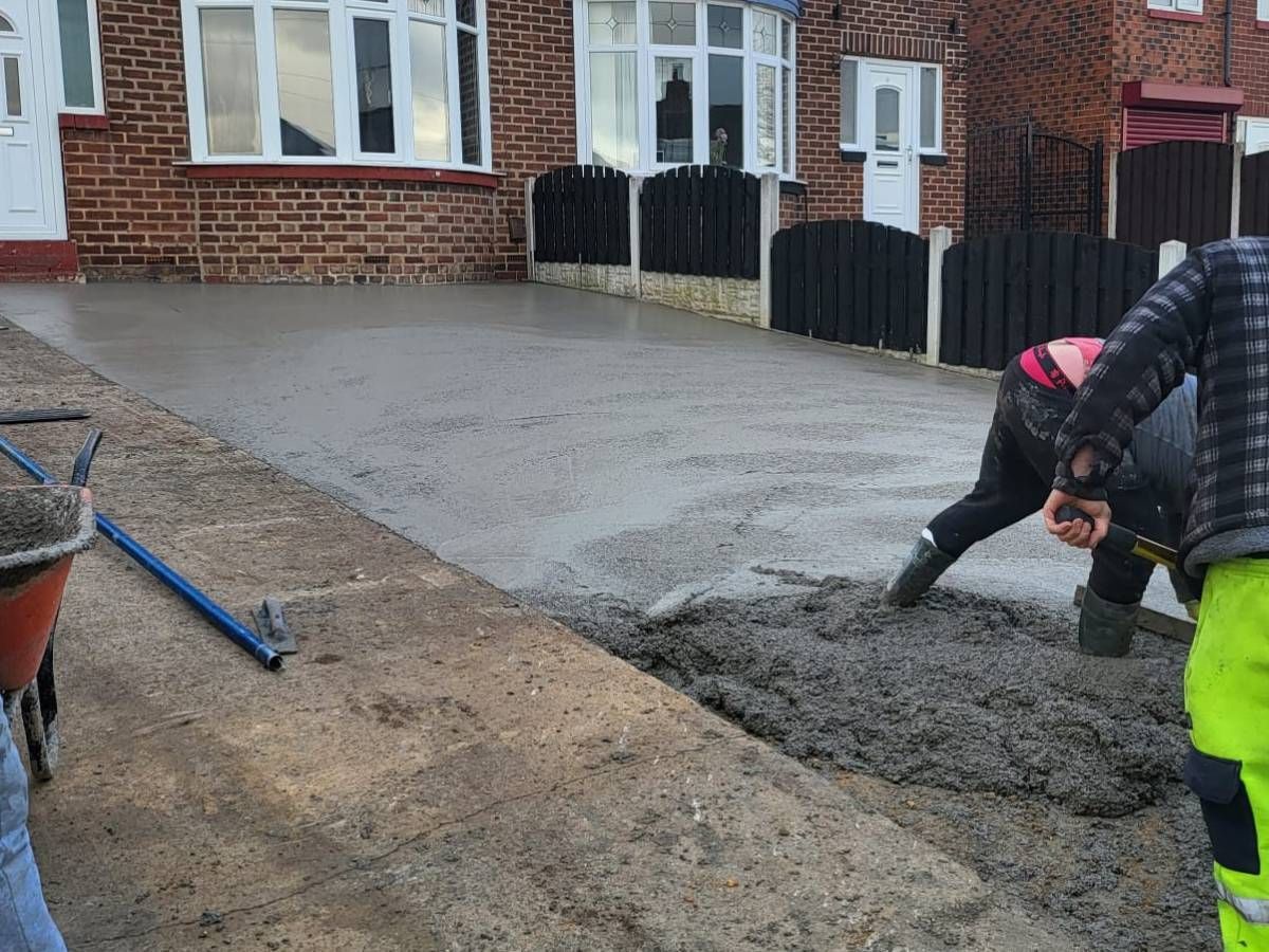 Driveways Rotherham concrete being spread for a driveway in Whiston Rotherham