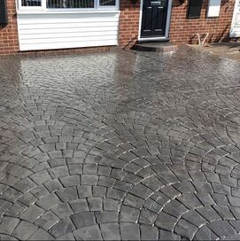 Grey fan-pattern imprinted concrete driveway outside a house in Rotherham