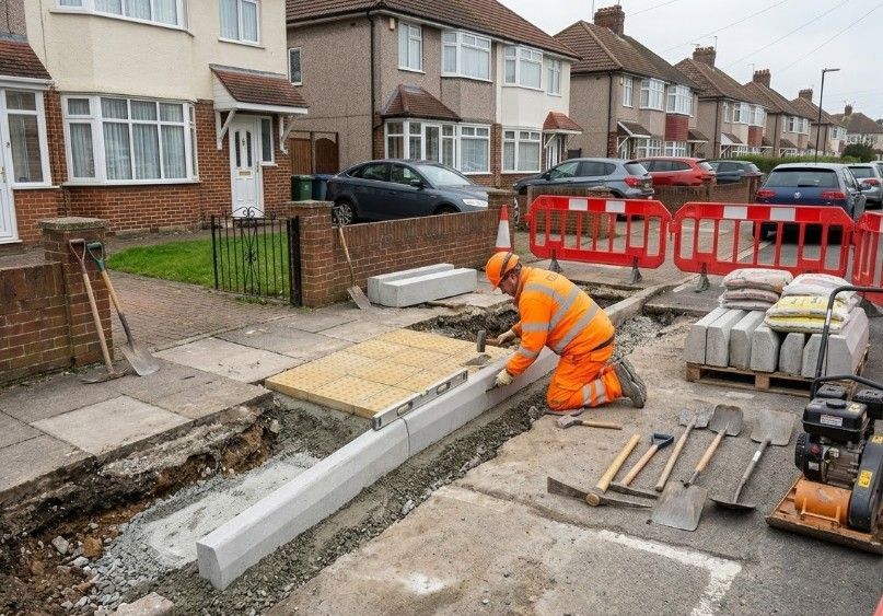 Dropped kerb units being installed in a footpath