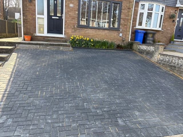 Charcoal herringbone block paving driveway at a semi-detached house