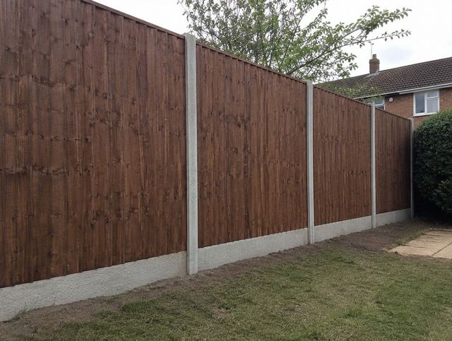 Close-board timber garden fence with concrete posts