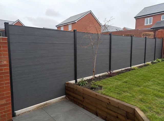 Dark grey composite garden fence with metal posts