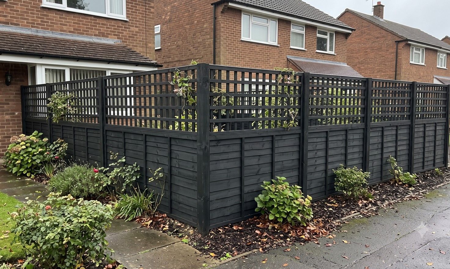 Timber garden fence with decorative trellis top section at a residential property in Rotherham