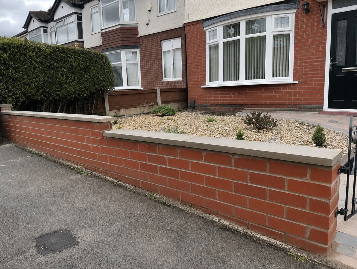 Red brick front garden wall with stone coping