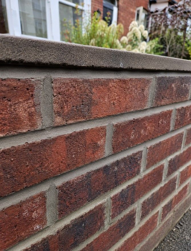 Professional brick repointing on a garden boundary wall in Rotherham