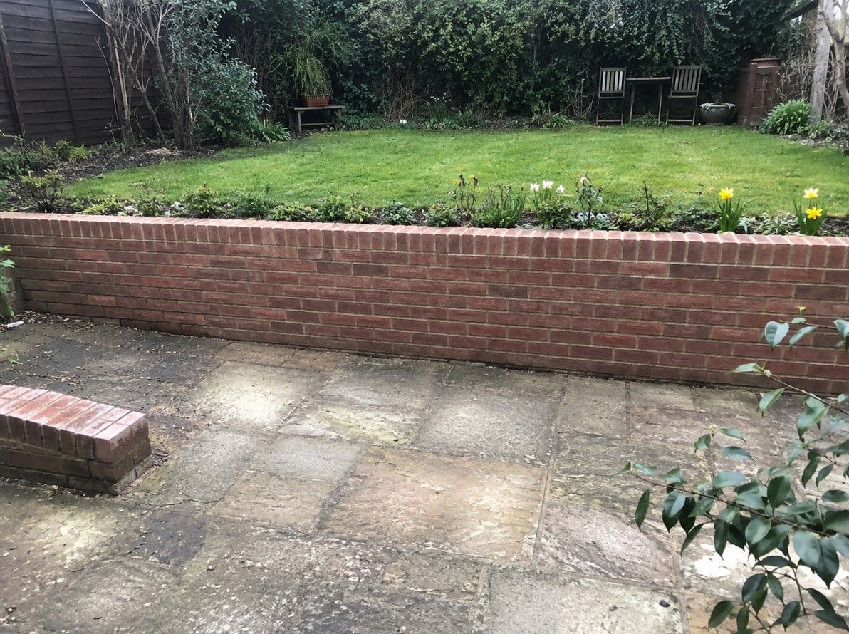 Brick retaining wall creating a level tiered garden at a residential property in Rotherham
