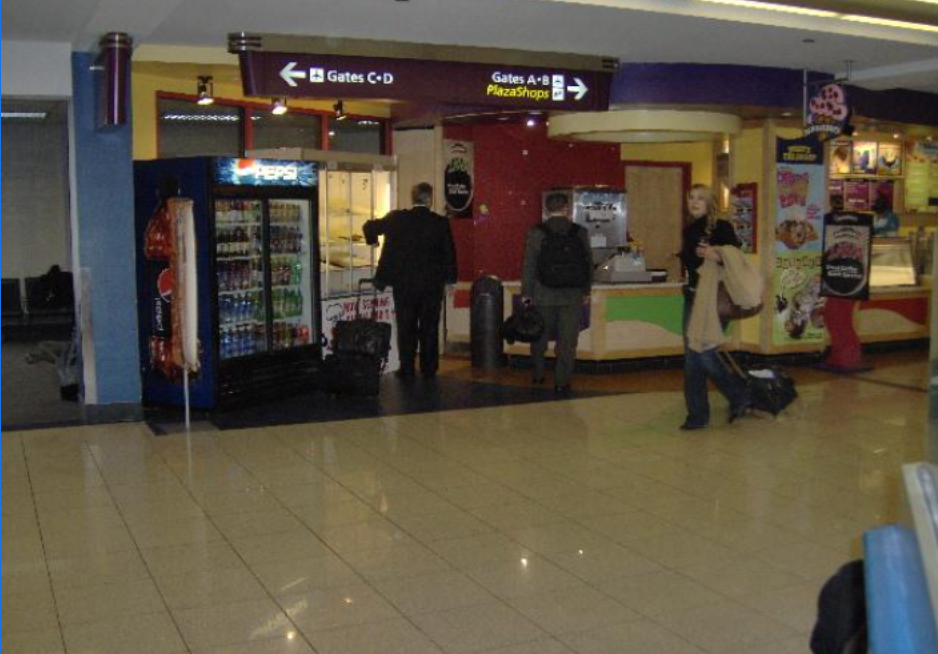 A pepsi vending machine is in the middle of a store