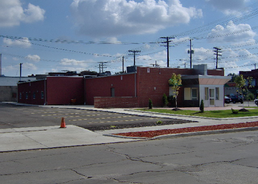 A brick building sits on the corner of a street