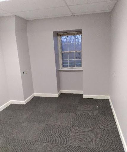 There is a window in the corner of the room.