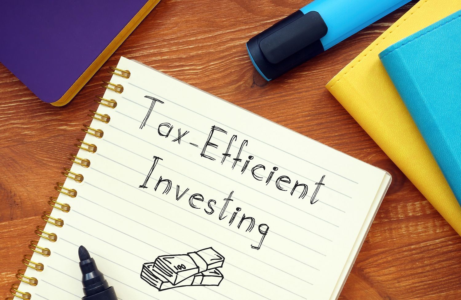 A notebook with the words `` tax efficient investing '' written on it.