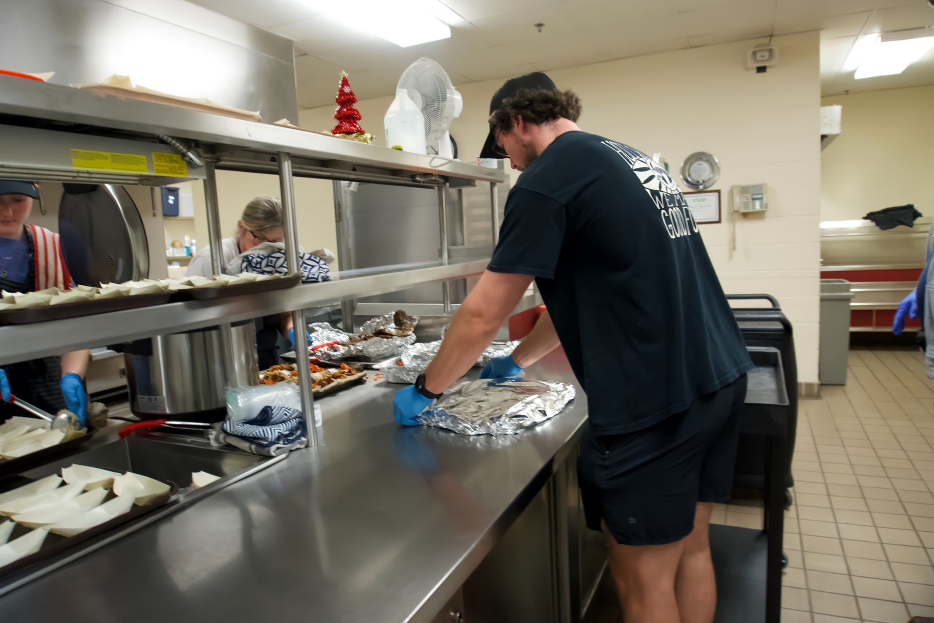 A man is cleaning a counter in a kitchen.