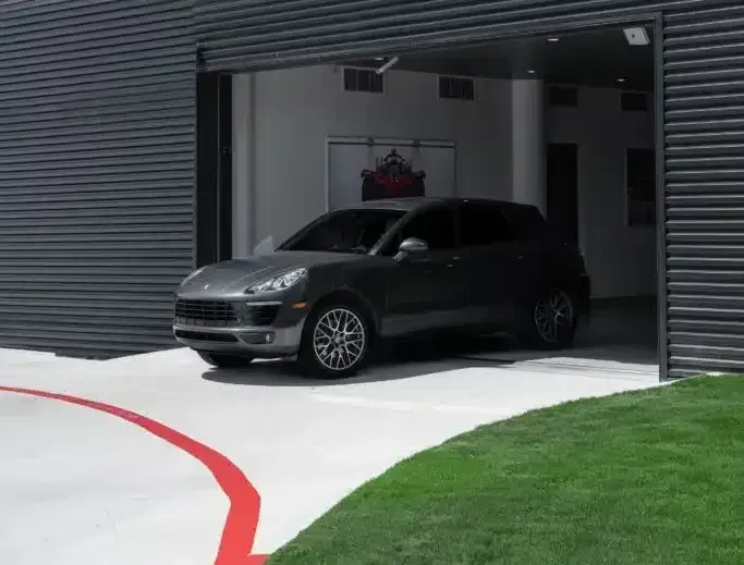 Man using a remote controller to open the garage door.