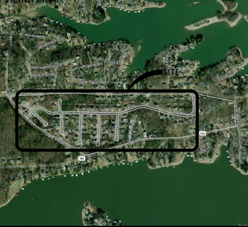 Aerial view: a residential area bordered by a lake. 