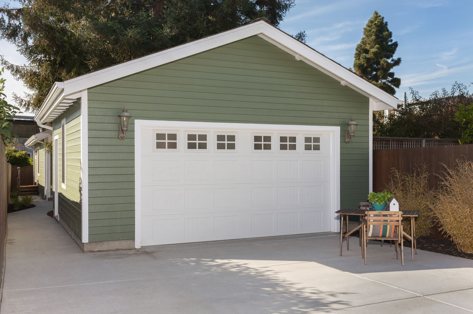 Side view of house exteriors and new garage entrance. Side view of house exteriors and new garage entrance.