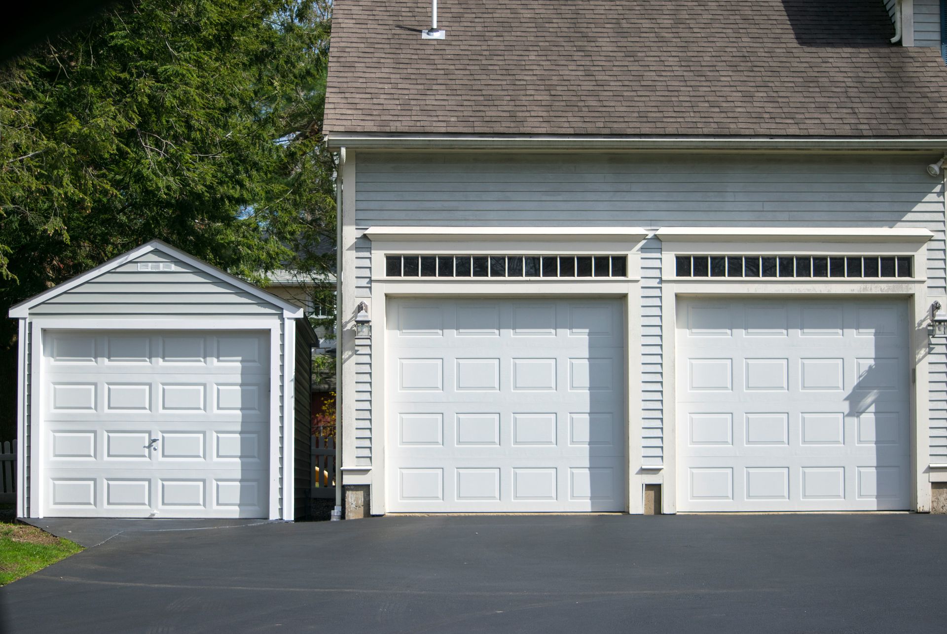 Attached garage door on a residential home with a smooth paved driveway