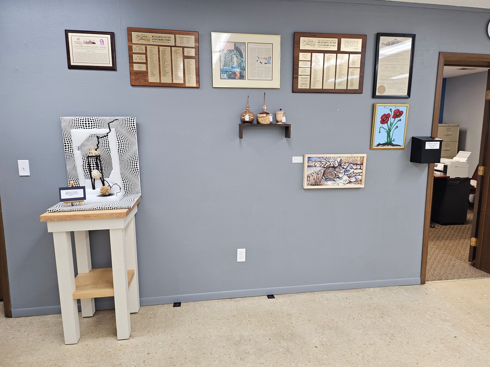 A room with a table and pictures on the wall