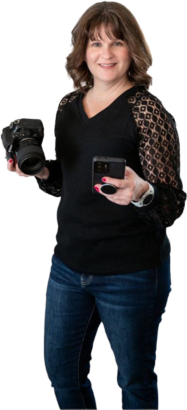 A woman is holding a camera and a cell phone.