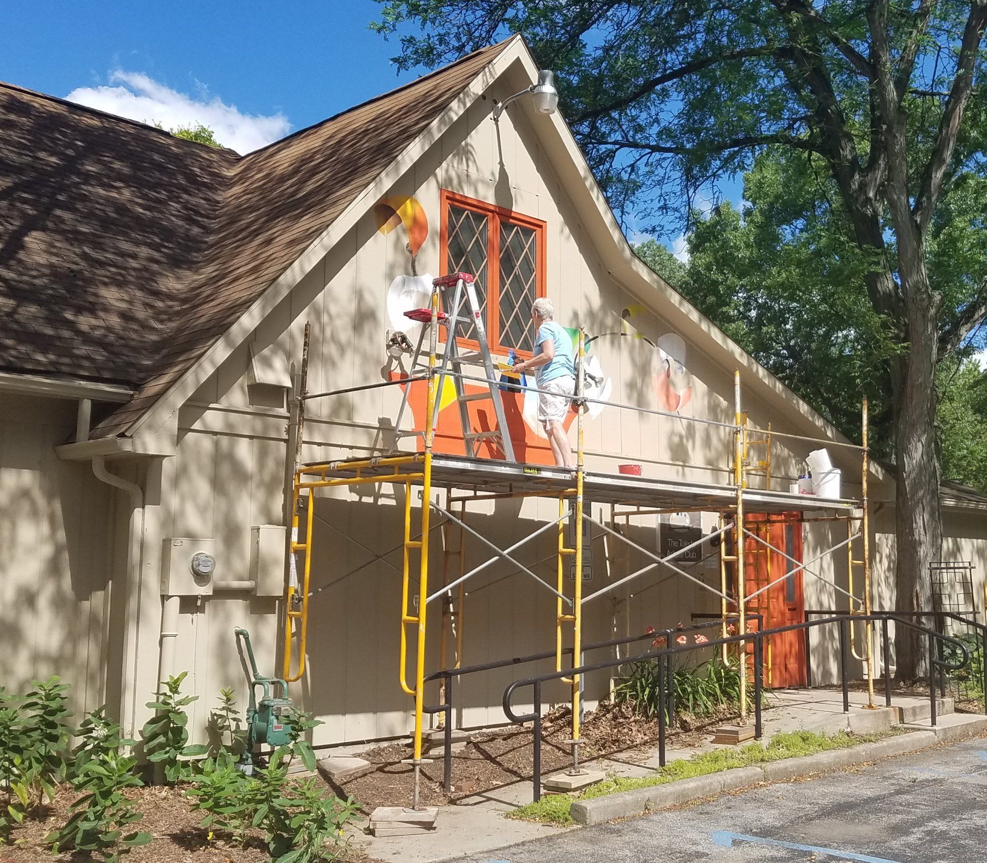 A building that is being painted with scaffolding around it
