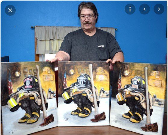 A man is holding three paintings of a fireman
