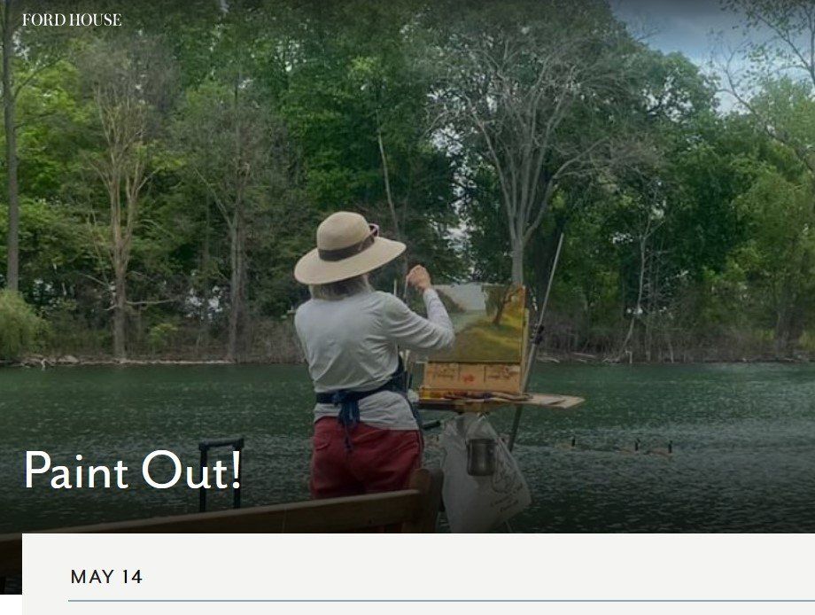 A woman in a hat is painting a picture of a lake.