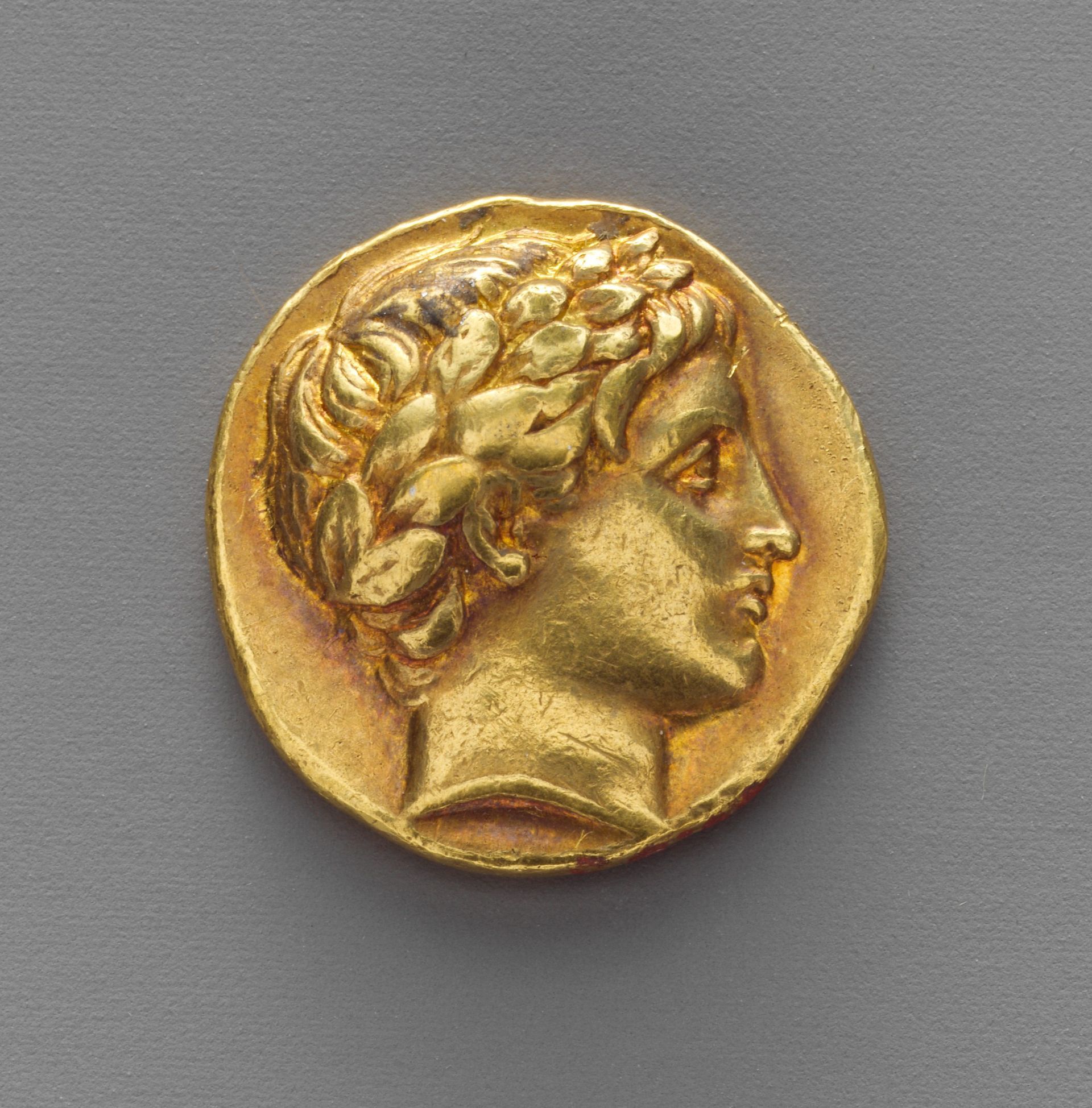 A gold coin with a woman 's head on it