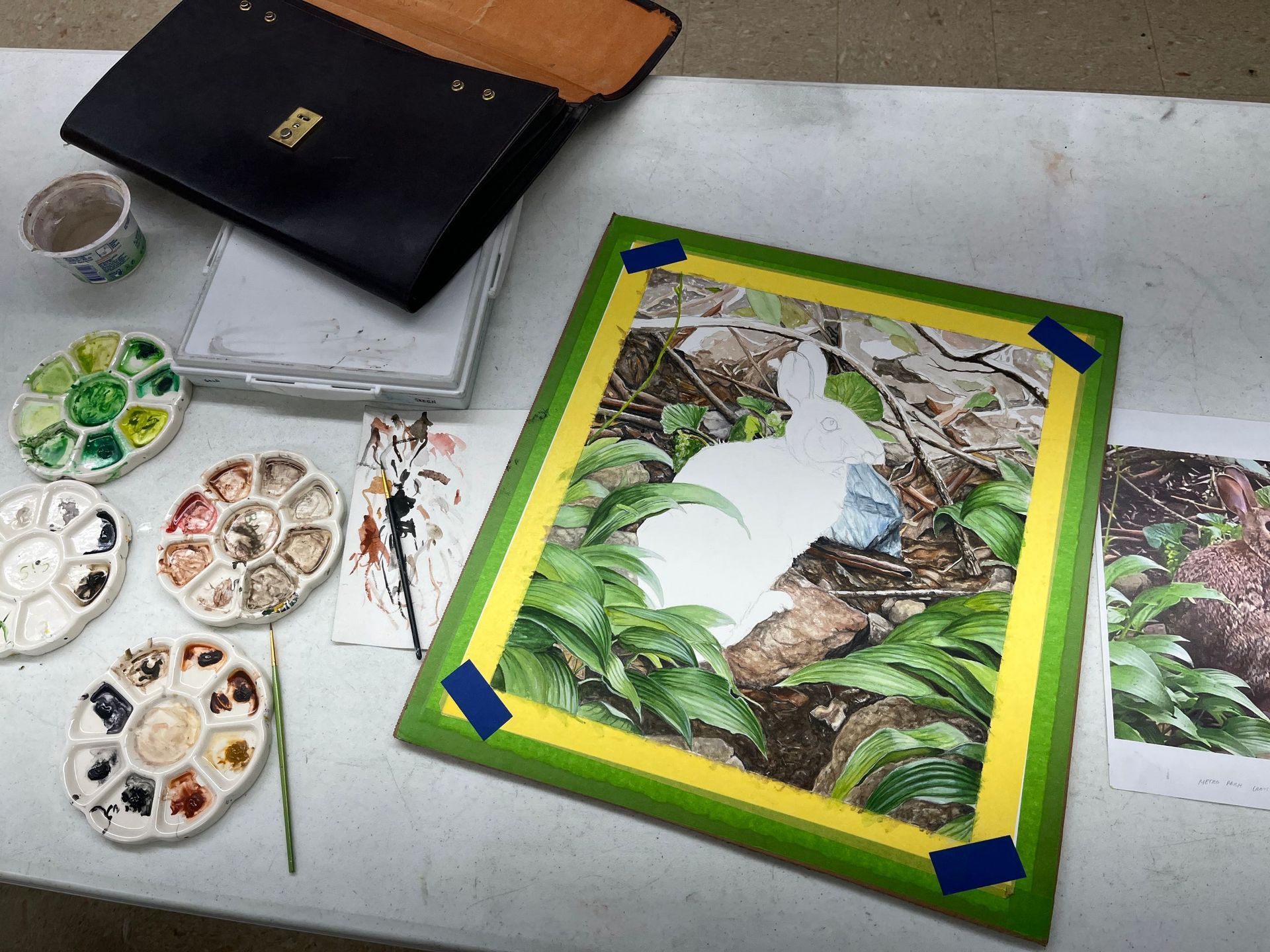 A woman is painting a picture on a table