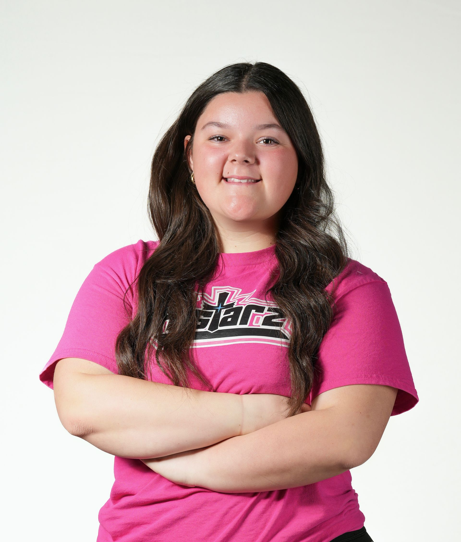 A woman wearing a blue ncaa shirt and black shorts