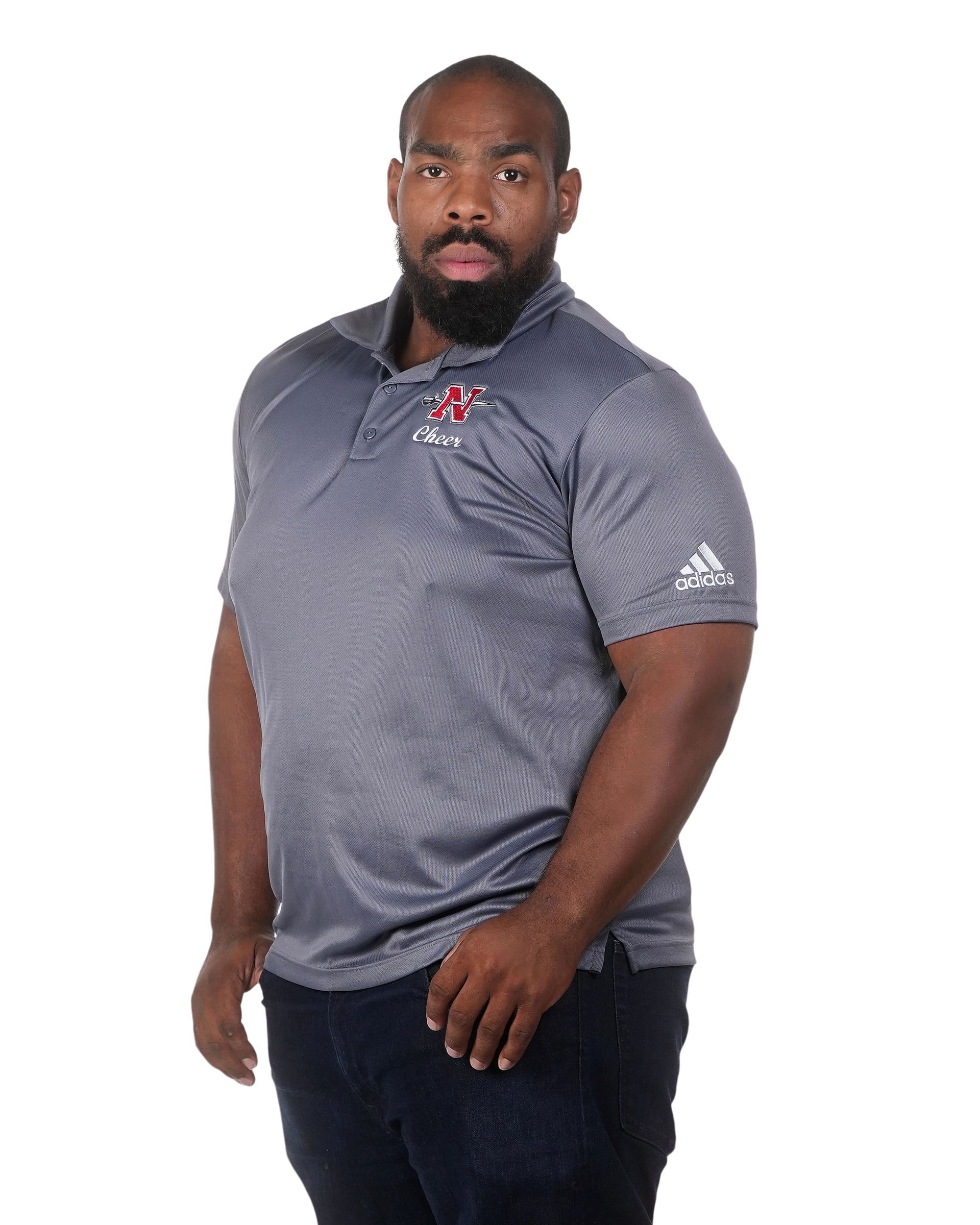A man with a beard is wearing a gray adidas polo shirt.