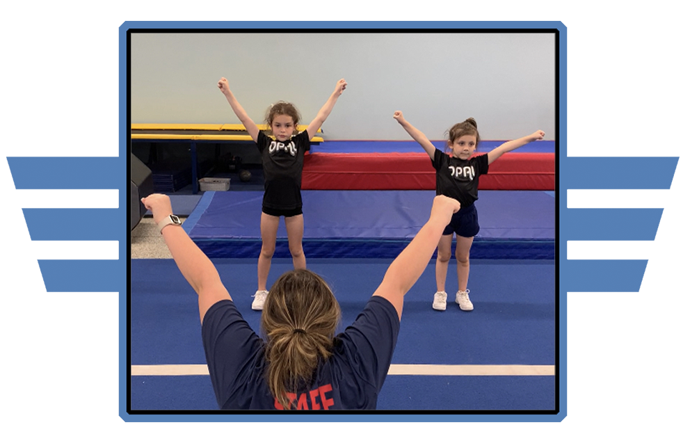A woman is teaching two young girls how to do gymnastics.