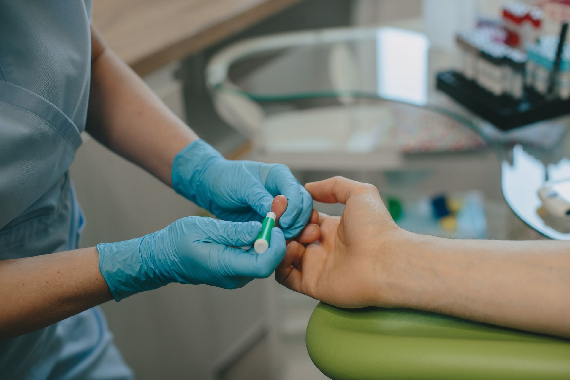 Gloved dental professional cleaning a patient’s teeth in a clinic