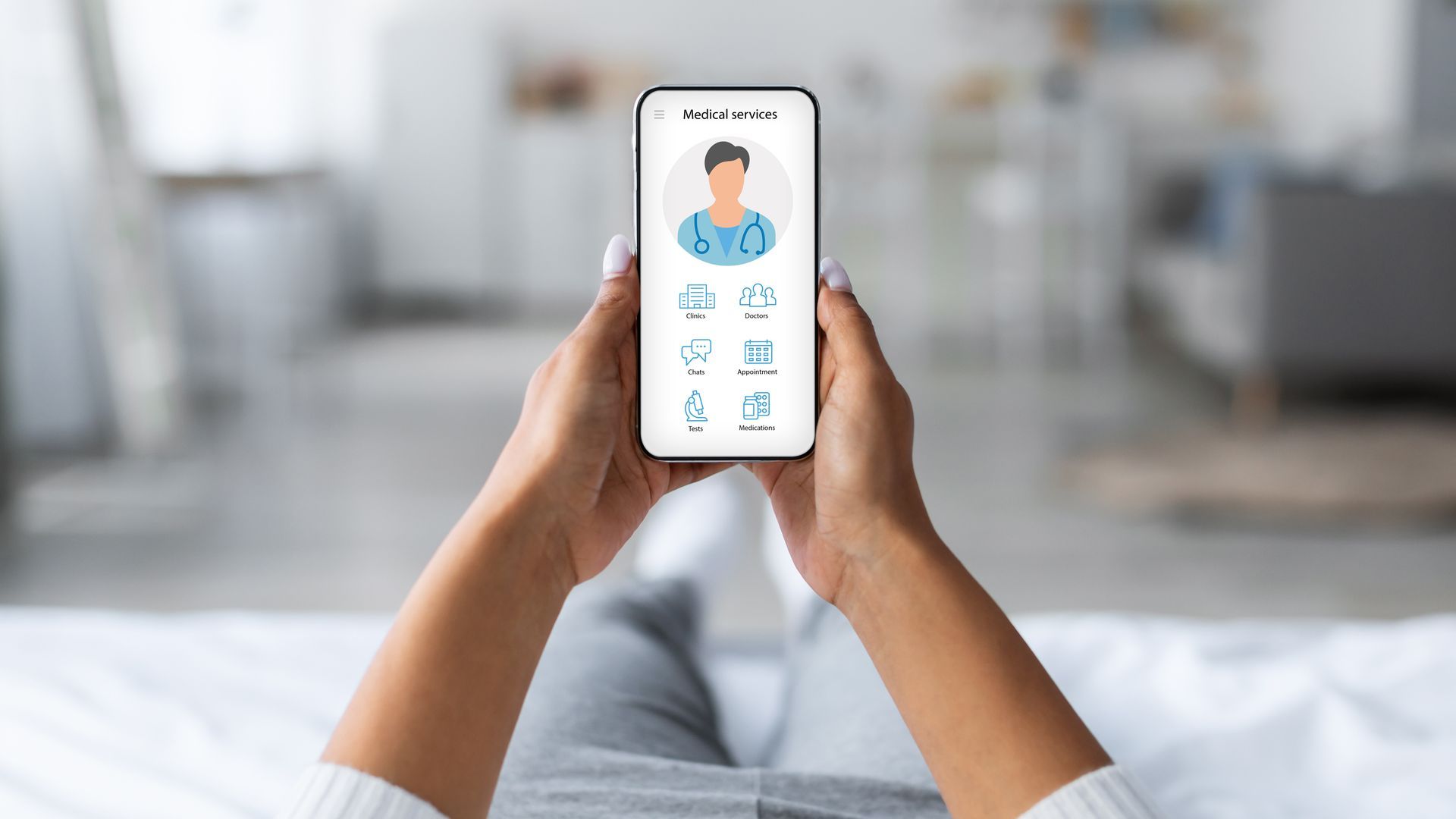 Hands holding a smartphone showing a healthcare app with a doctor illustration on the screen.