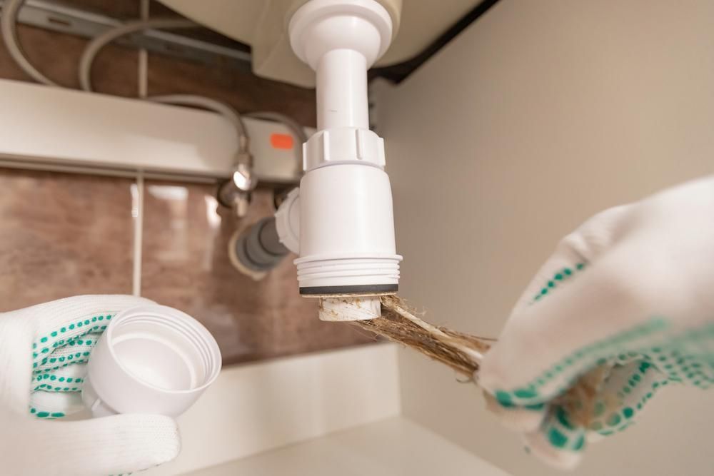 Hands in Gloves Using a Wrench to Unscrew — ABV Plumbing In Woy Woy, NSW