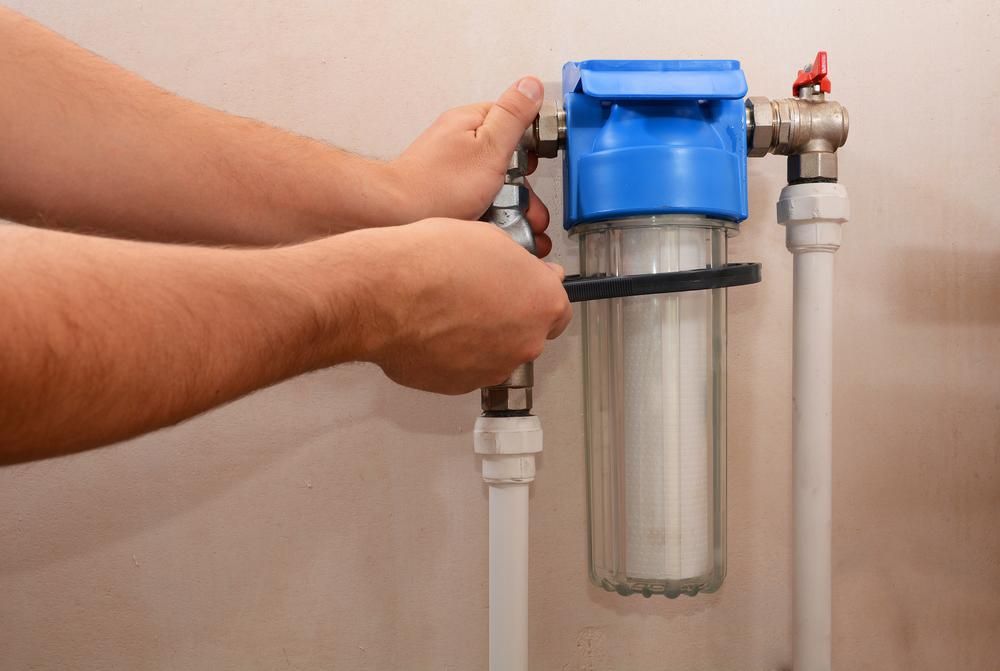 Person Using a Wrench to Work on a Water Filter System — ABV Plumbing In Erina, NSW
