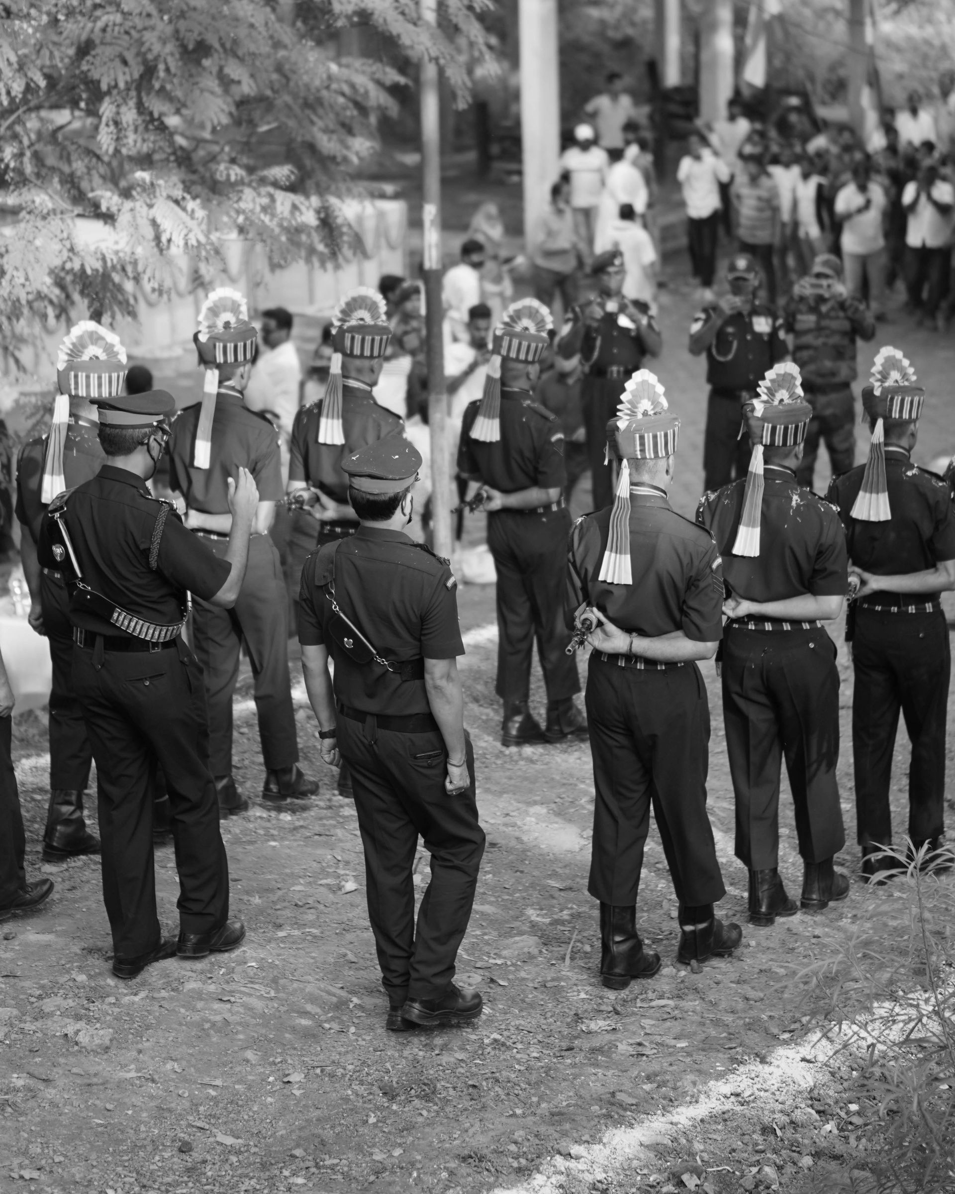 A black and white photo of a group of people standing next to each other.