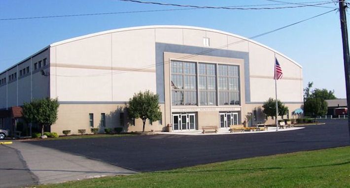 A large building with a flag in front of it