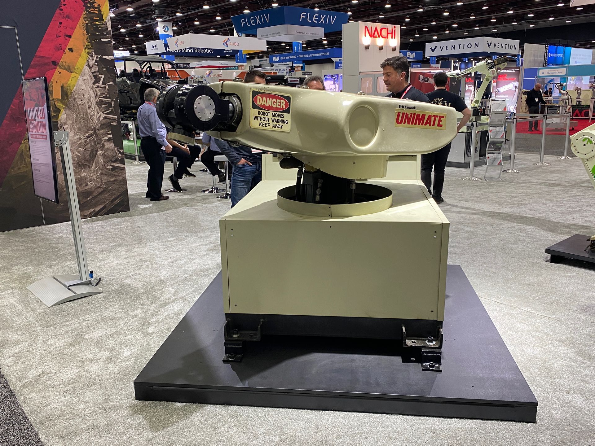 A robotic arm is on display at a convention.
