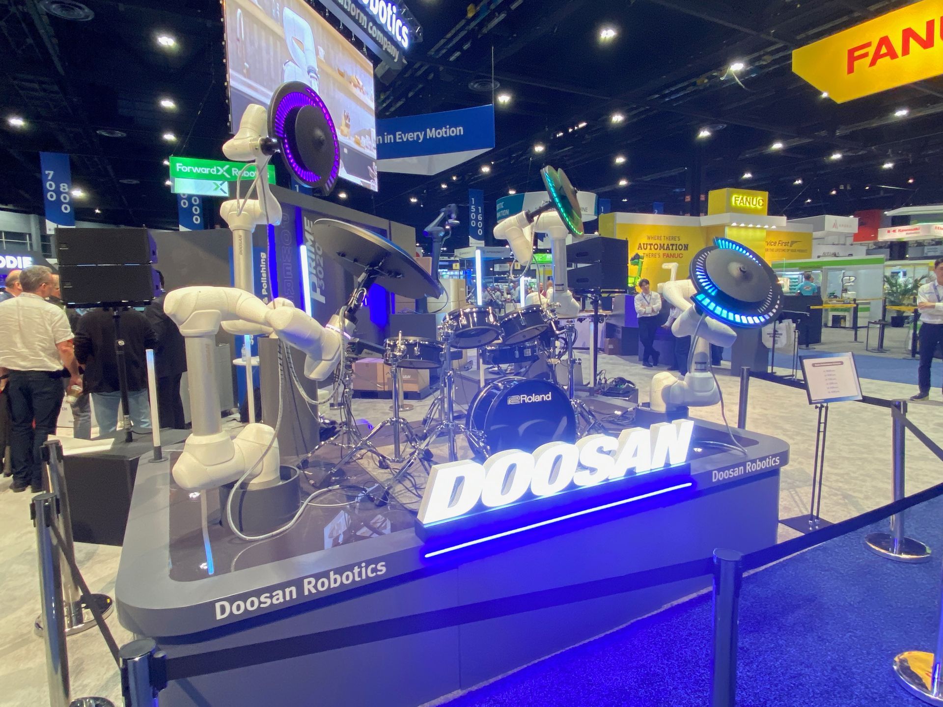 A doosan robotic machine is on display at a convention.