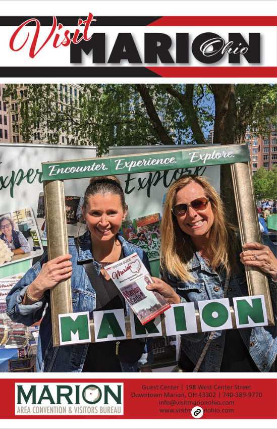 Two women are holding a sign that says marion on it.