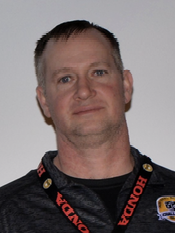 A man wearing a honda lanyard around his neck