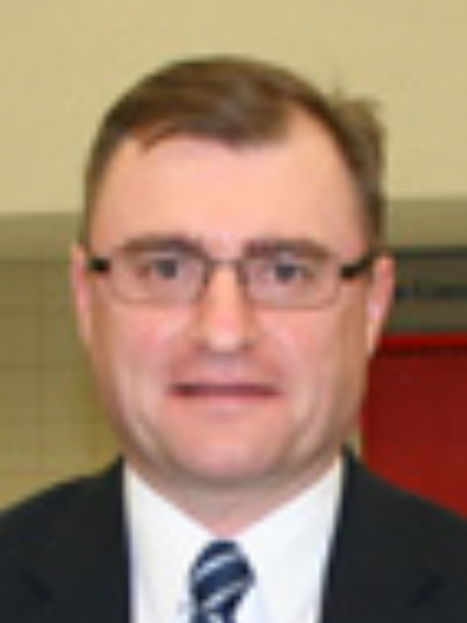 The man is wearing glasses and a suit and tie